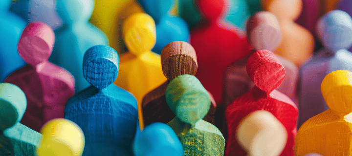 Colourful wooden figures symbolising individuality and the human element in financial planning